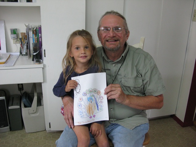 Sophia and a peacock picture she colored for me